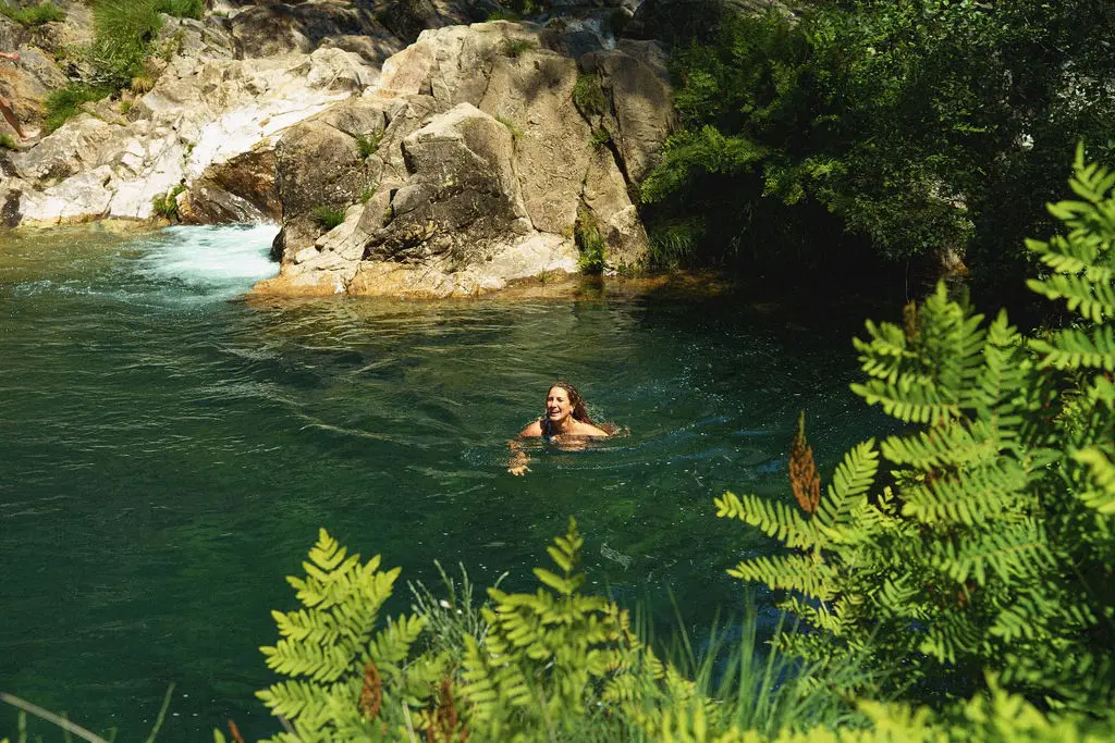 Swimming in a natural river pool after a day's ride