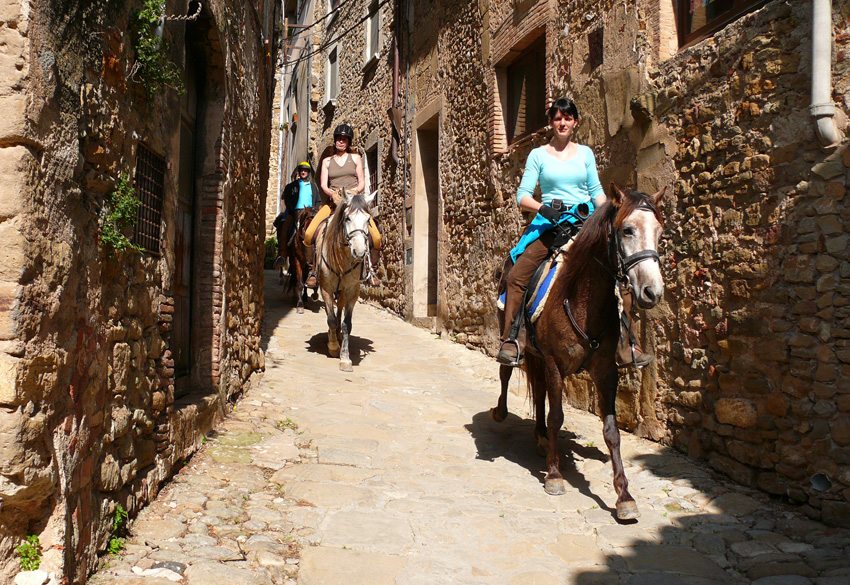 Ride through local villages while on the Catalonia Coast horseback riding vacation in Spain